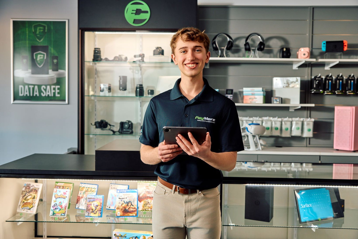 paymore employee holding a tablet and smiling

