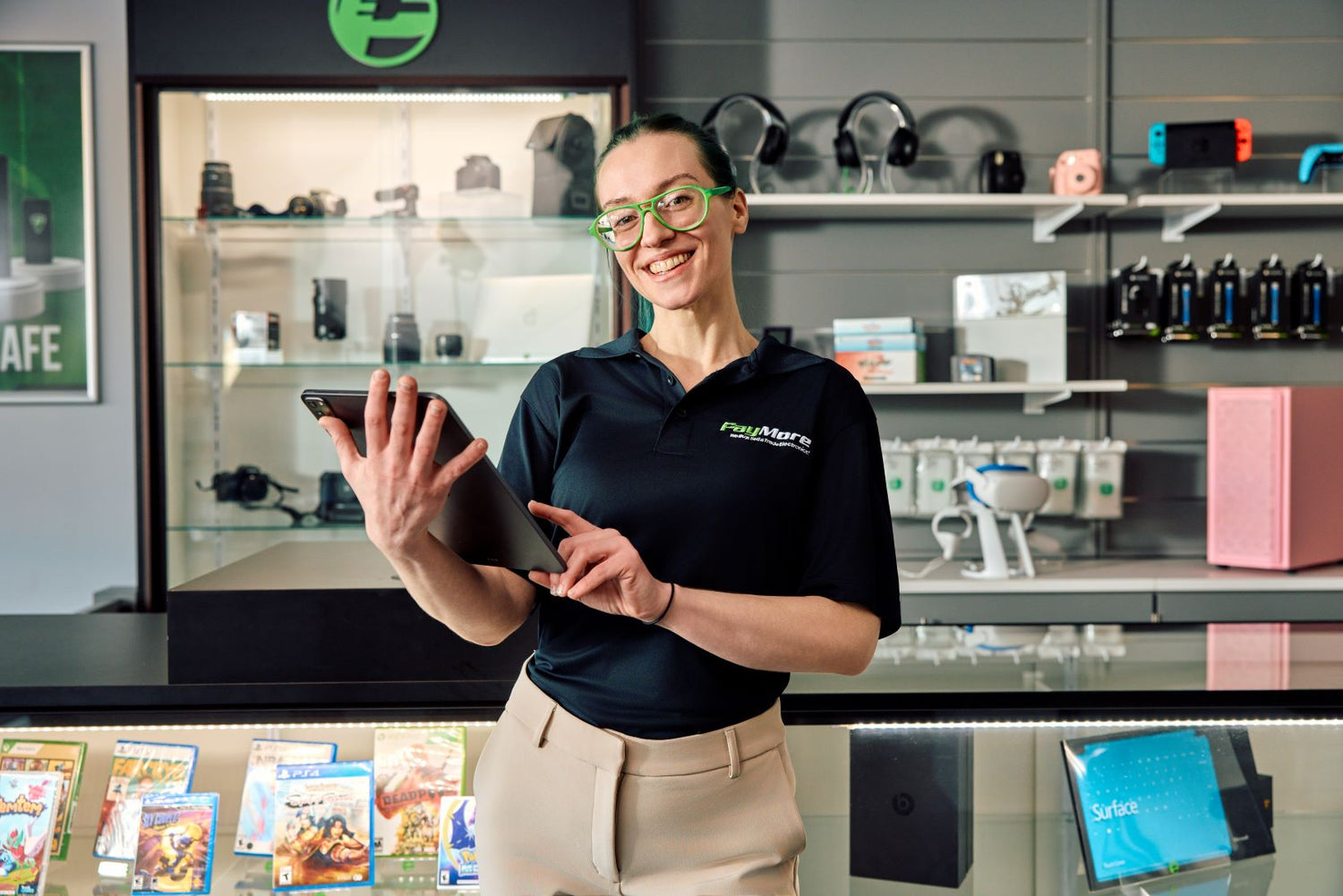 paymore employee holding a tablet and smiling
