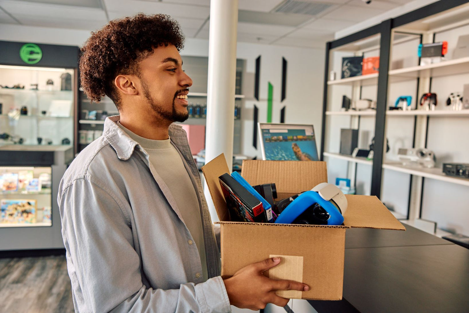 man holding a box of electronics
