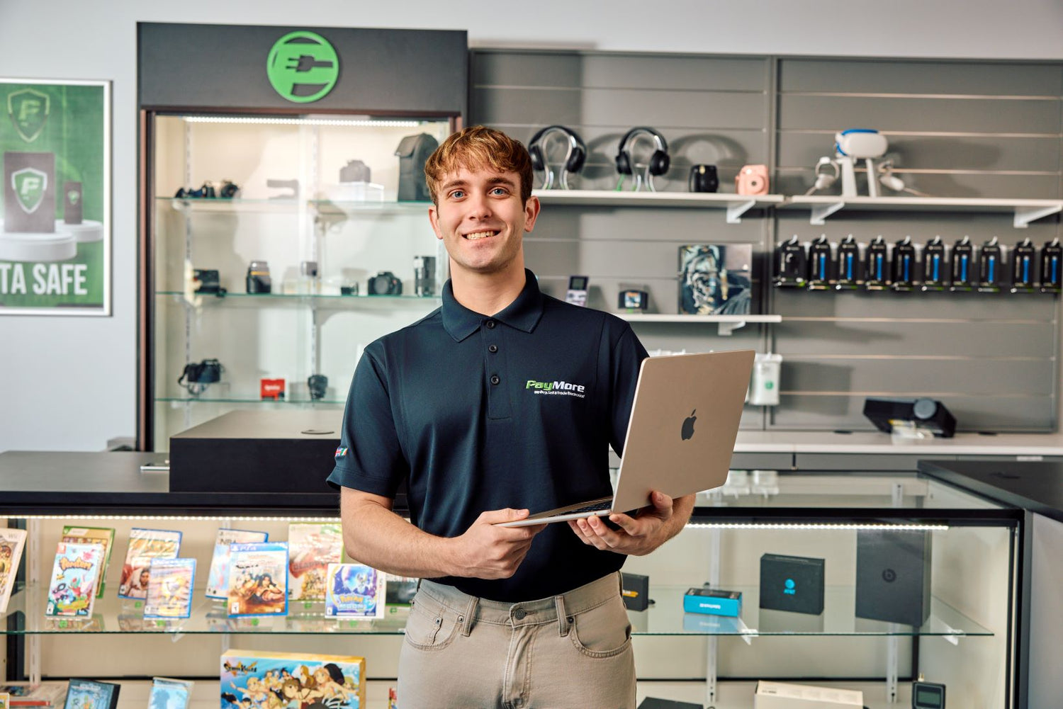 paymore employee holding a laptop and smiling
